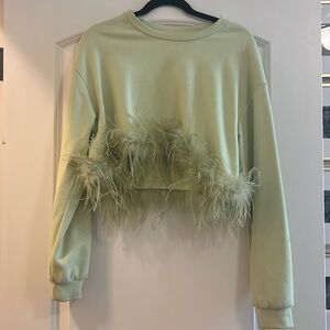 Long sleeve top with feathers on bottom